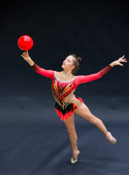 istock Young Rhythmic Gymnastics Athlete Balancing Ball on Her Finger 958493752