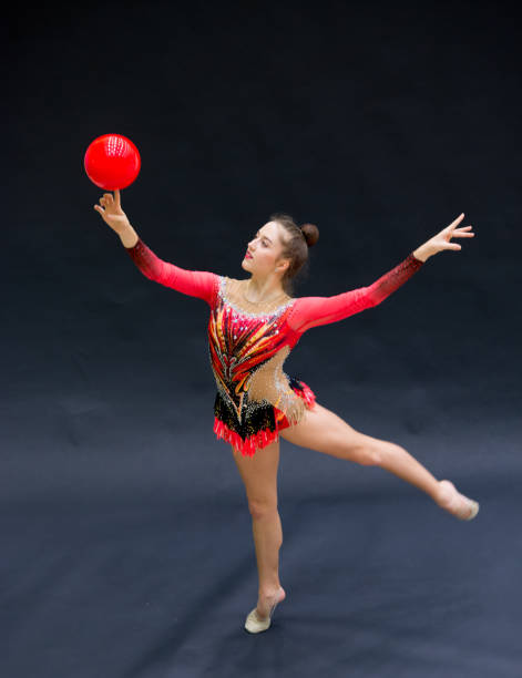 istock Young Rhythmic Gymnastics Athlete Balancing Ball on Her Finger 958493768