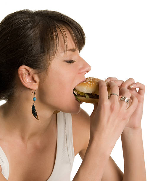 istock Beutirful girl eating harmful sandwich 95849894