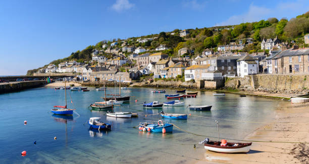 Mousehole Fishing Village Near Penzance in Cornwall, England Fishing Boats Moored in the Harbour cornwall england photos stock pictures, royalty-free photos & images