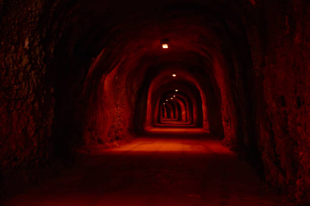 a mine tunnel. focus on the entering train.