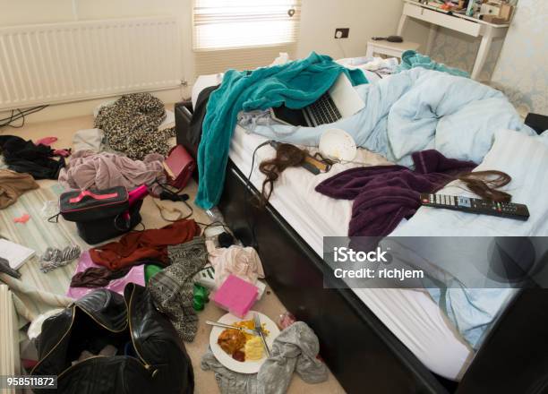 Showing Mess In A Teenage Girls Bedroom Including Food Clothes And Bags Stock Photo - Download Image Now