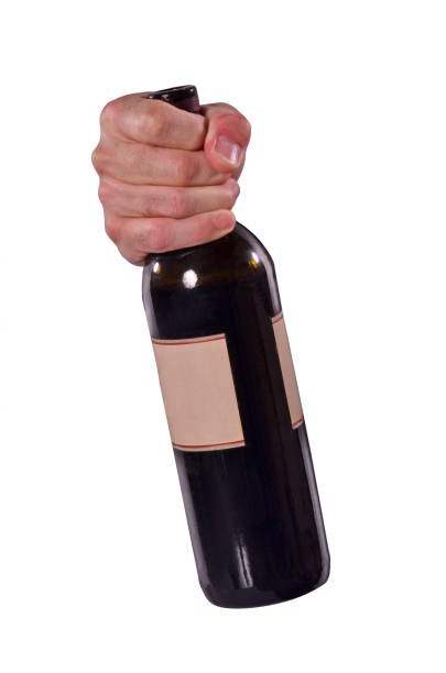 istock The hand hold the red wine bottle before open it. 958514972