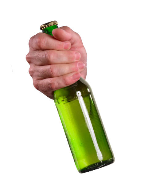 The hand is holding a fresh beer bottle on white background. Hand hold green glass beer bottle on white background. man hand holding candy bar stock pictures, royalty-free photos & images