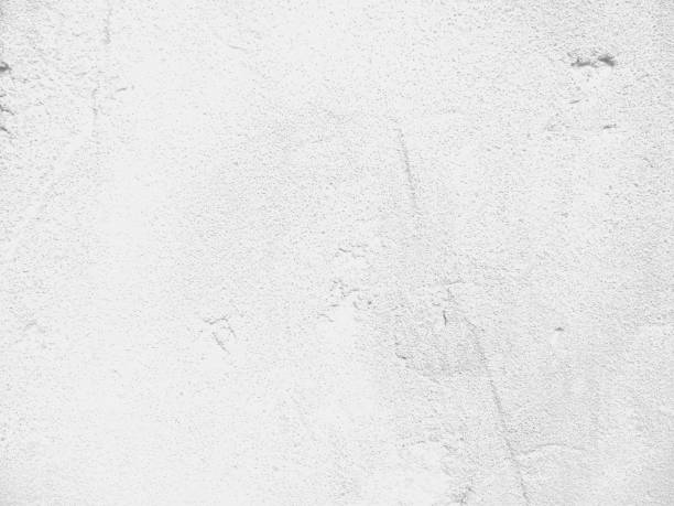 istock Texture of a white wall, abstract background of a surface with cement, light pattern for a designer, minimalistic background 958518578