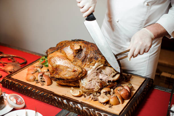 istock Man cutting baked chicken with a knife in a restaurant 958519554