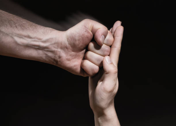 istock The female palm stops a male punch. 958522280
