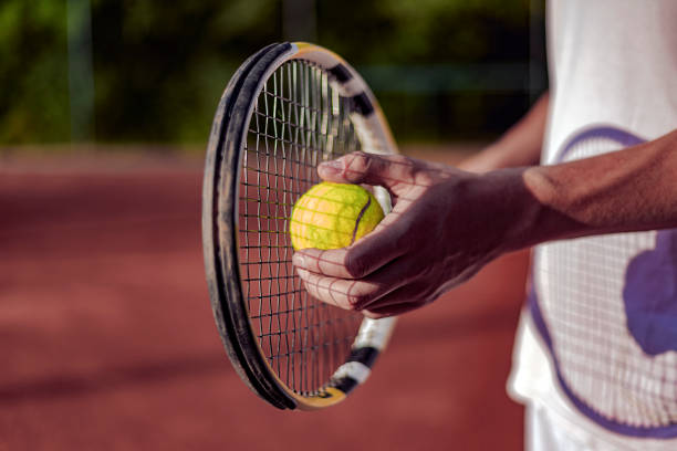 istock Cropped image of man playing tennis 958522498