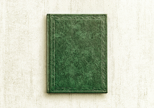 mock up book green color on gray background close-up, top view