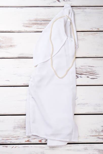 istock Women white shirt on wooden background. 958526580