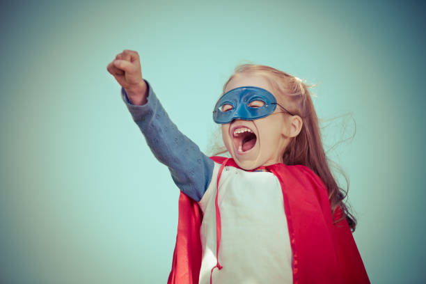 istock Funny little girl playing power super hero. 958526824