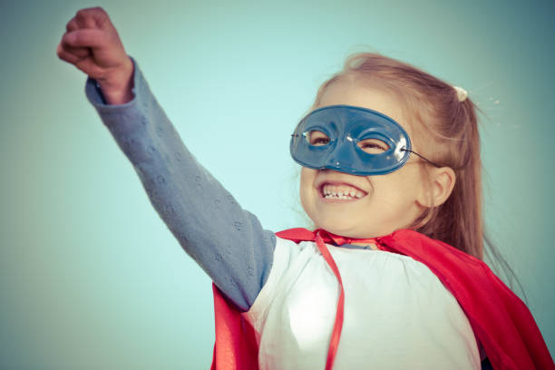 istock Funny little girl playing power super hero. 958526862