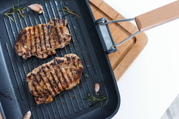 istock Two Grill Steaks On a Grill Pan. Top View. 958526966