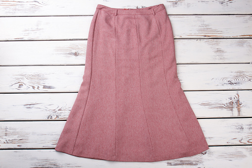 Classy female skirt, wooden background. Beautiful women skirt on sale. Female classic outfit.