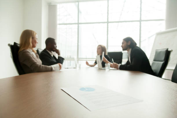 istock Business plan on conference table with executives meeting at background 958531252