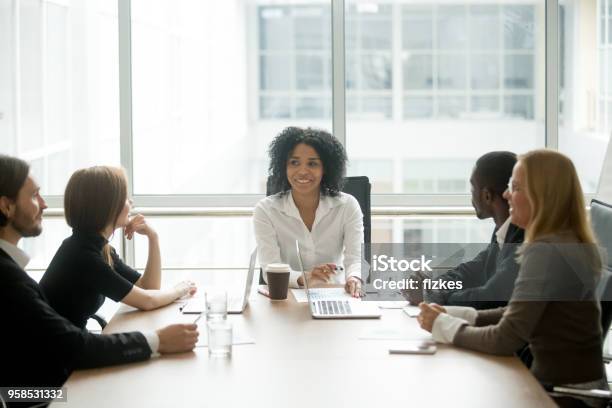 Black Female Boss Leading Corporate Meeting Talking Diverse Businesspeople Stock Photo - Now - iStock