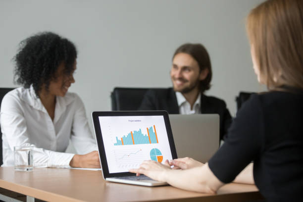istock Businesswoman working with project statistics preparing report at team meeting 958531396