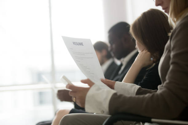 Multiracial business people waiting in queue preparing for job interview Multiracial business people waiting in queue preparing for job interview concept, diverse unemployed vacancy applicants holding reading cvs getting ready, human resources concept, focus on resume unemployment stock pictures, royalty-free photos & images