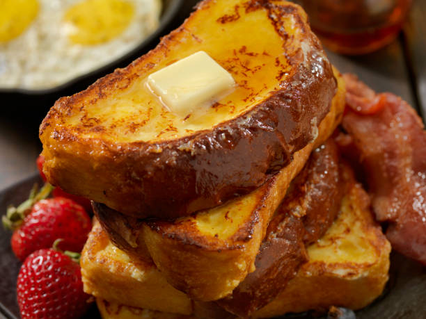 Brioche French Toast with Bacon and Eggs Brioche French Toast with Bacon, Eggs and Fresh Fruit french toast bacon bread butter stock pictures, royalty-free photos & images