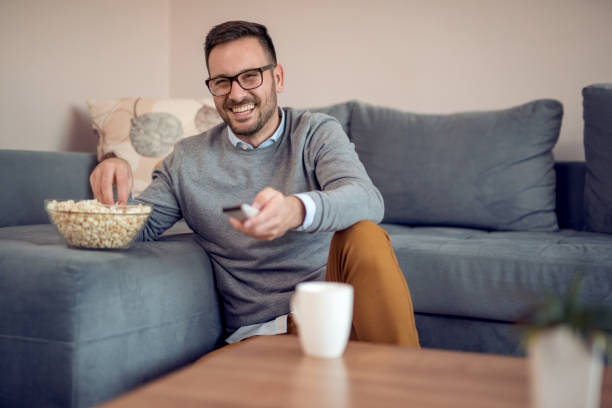 istock Man watching tv at home 958542732