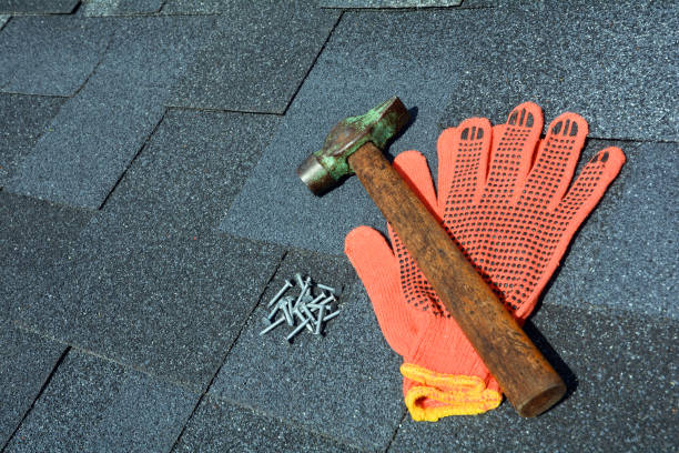 istock Close up view on asphalt roofing shingles background with hammer and nails. 958546608