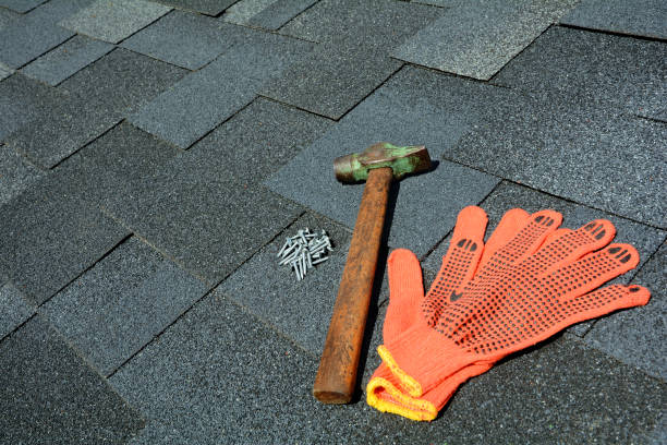 istock Close up view on asphalt roofing shingles background with hammer and nails. 958546610