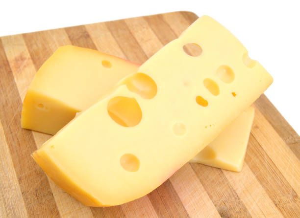 istock piece of cheese isolated on wooden board 958546688