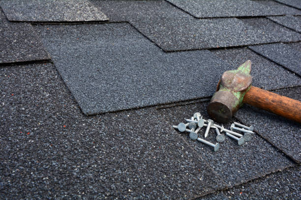 istock Close up view on asphalt roofing shingles background with hammer and nails. 958546724