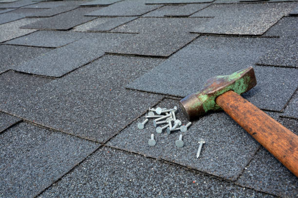 istock Close up view on asphalt roofing shingles background with hammer and nails. 958546728