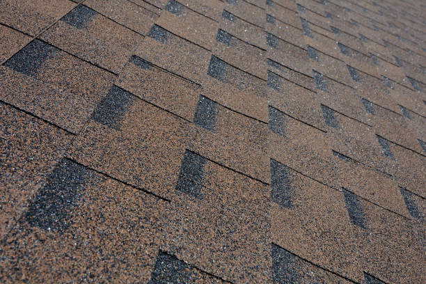 istock Close up view on asphalt roofing shingles background. 958546832