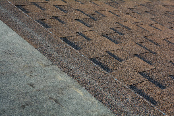 istock Close up view on installing Asphalt Bitumen Roof Shingles. 958546840