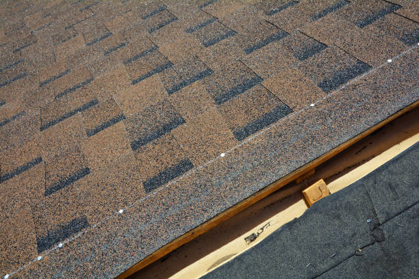 istock Close up view on installing Asphalt Bitumen Roof Shingles. 958546850
