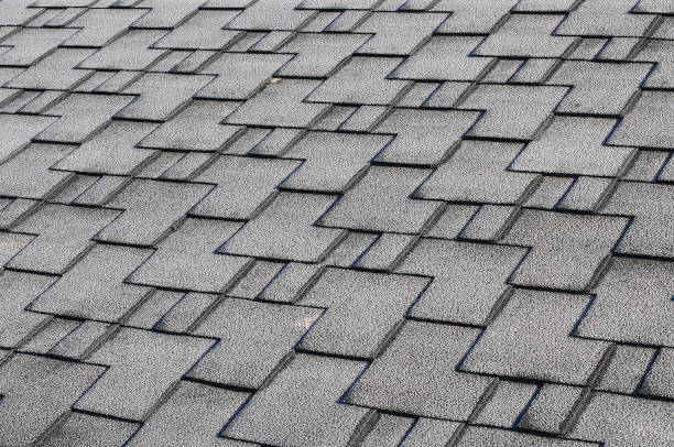 istock Close up view on asphalt roofing shingles covered with frost 958547064