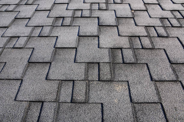 istock Close up view on asphalt roofing shingles covered with frost 958547074