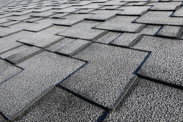 istock Close up view on asphalt roofing shingles covered with frost 958547088