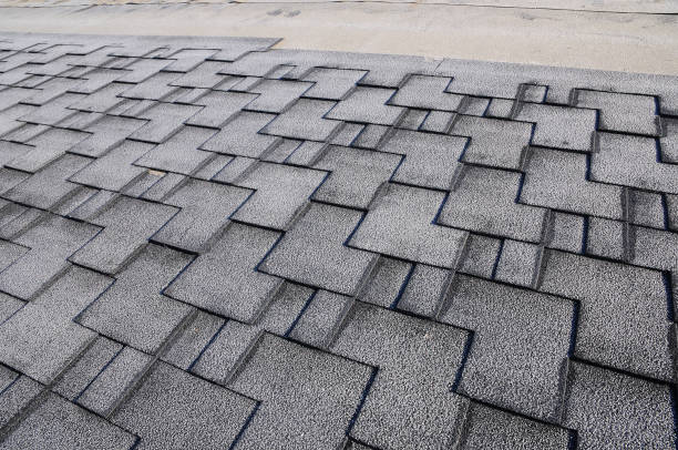 istock Close up view on asphalt roofing shingles covered with frost 958547102