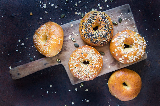 Bagels on old cutting board.