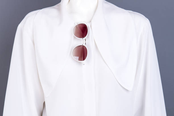 istock Close up white female blouse and sunglasses. 958551422