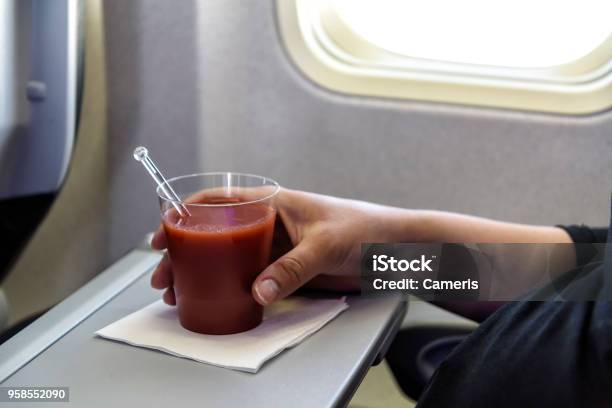 Tomato Juice In An Airplane Stock Photo - Download Image Now - Tomato Juice, Airplane, Airplane Seat