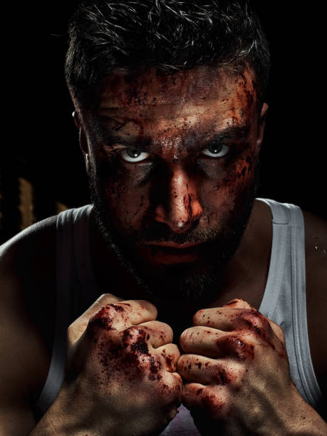 istock Portrait of a strong man with a beard, face in blood. 958552882