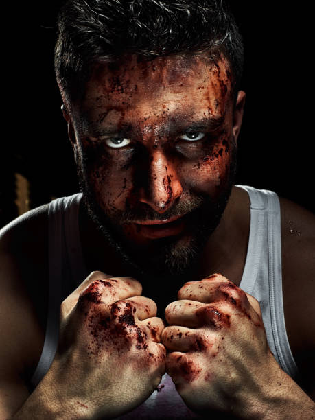 istock Portrait of a strong man with a beard, face in blood. 958552920