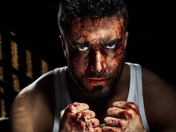 istock Portrait of a strong man with a beard, face in blood. 958552928