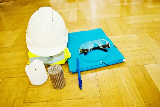 Photo of Candles, Hardhat, Reflex Jacket, File, Protective Glasses and Pen
