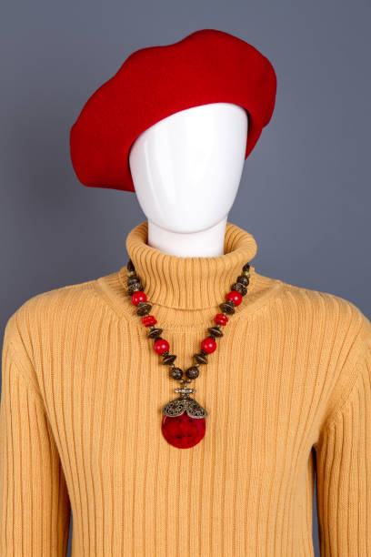 istock Red beret and necklace on mannequin. 958556364