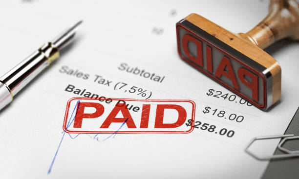 Paid Invoice, Debt or Invoice Collection Concept Rubber stamp with the text paid over an invoice document. 3D illustration. Payment of debts concept. debt recovery stock pictures, royalty-free photos & images