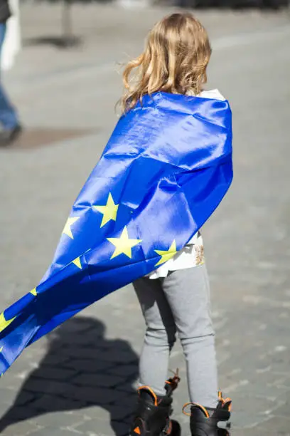 Photo of happy young blonde girl demonstrator sporting the European flag