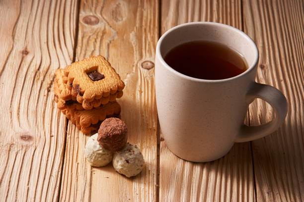 istock tee and cookies on a wooden table 958565590