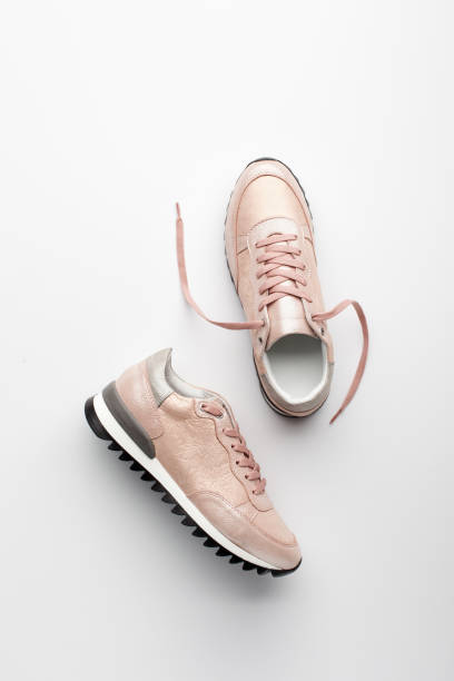 istock Pastel pink female sneakers on white background. 958565762