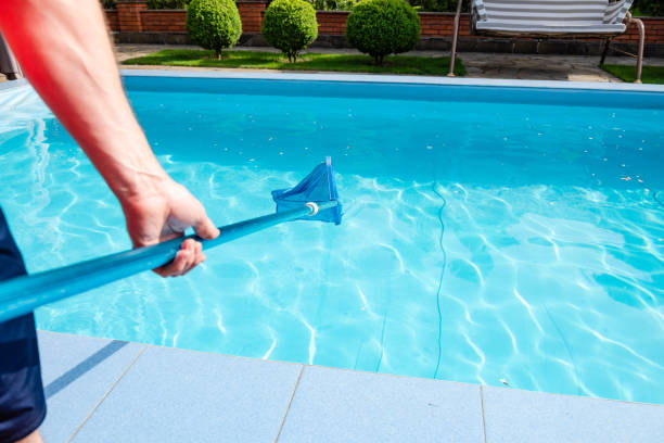 istock Male hand hold pool net cleaner 958565788