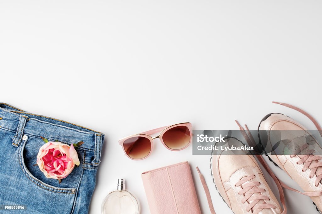Flat lay pink feminine clothes and accessories on white background. Flat lay pink feminine clothes and accessories on white background. Flat lay, top view. Springtime Stock Photo